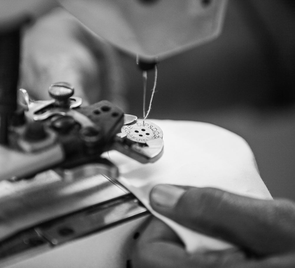 Close Up Of A Corozo Nut Button Being Attached To A Duvet Cover On A Sewing Machine | Dip &amp; Doze