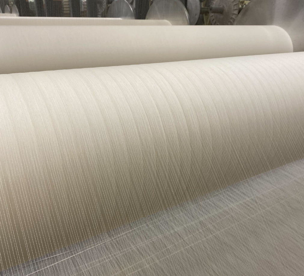 Close Up Of Sustainable Hemp Threads Being Woven Into Linen Fabric On A Weaving Machine | Dip &amp; Doze